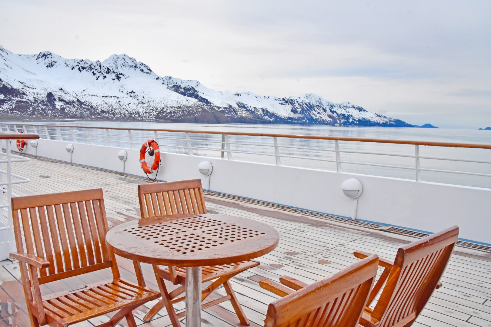 Star Legend deck and seating area with view of Alaskan mountains - Photo Credit: Kristina Buangin